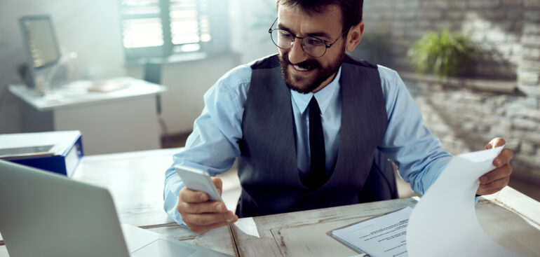 Businessman reviewing corporate tax compliance reports in Dubai office