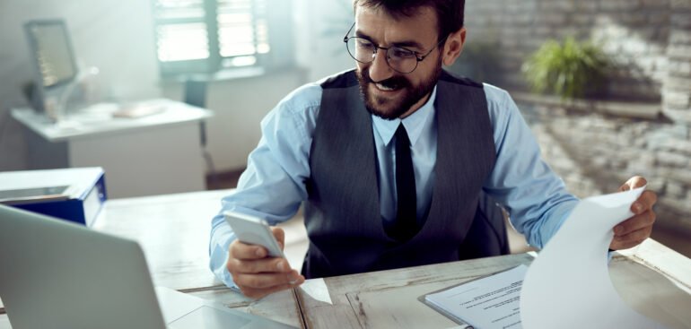 businessman reviewing corporate tax filing documents in Dubai office