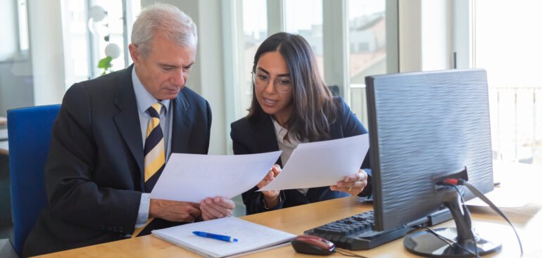 Business owner reviewing corporate tax filing documents in Dubai office